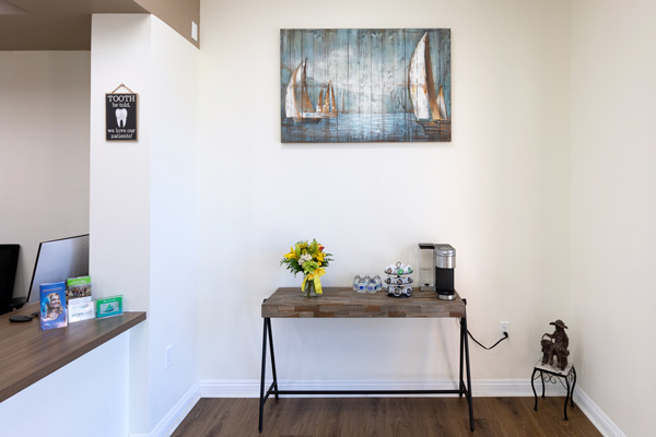 Front desk and painting of sailboats at Higher Ground Dentistry in Upland, CA