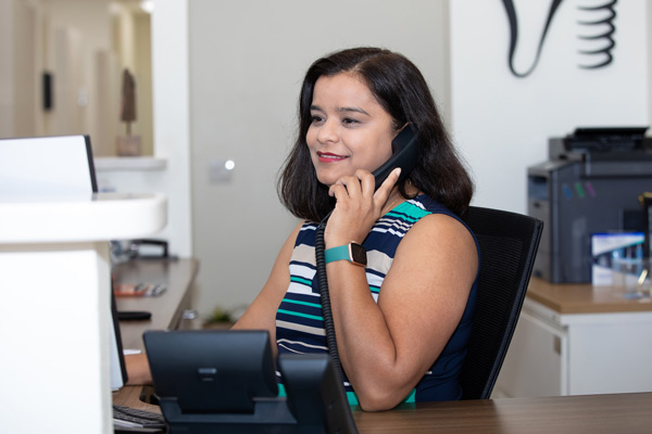 Team member answering phone at Higher Ground Dentistry in Upland, CA