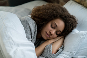 Woman peacefully sleeping in bed