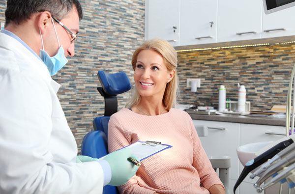 Woman talking to our Upland dentist during dental exam