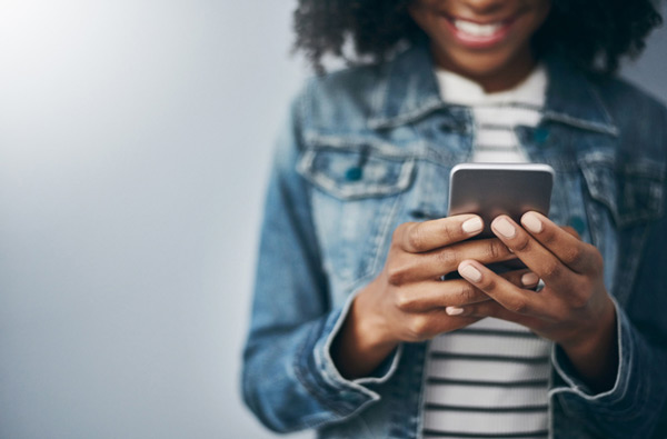 Woman looking at our dental website on her phone